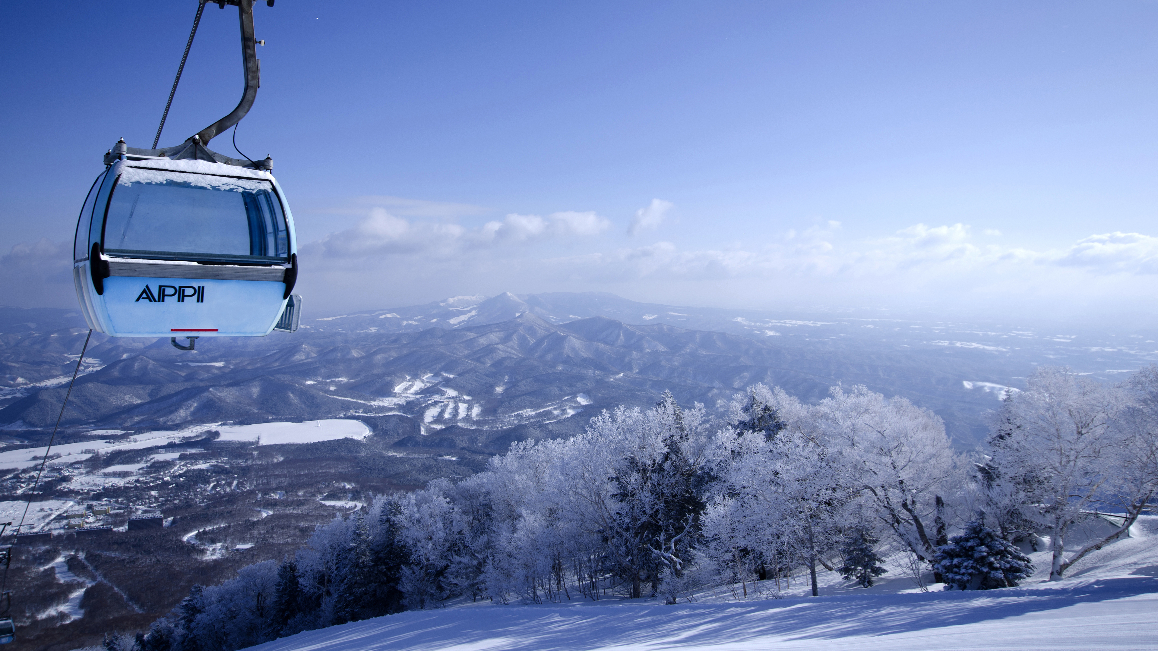 Gondola at Appi Kogen with snow-covered mountains in the background